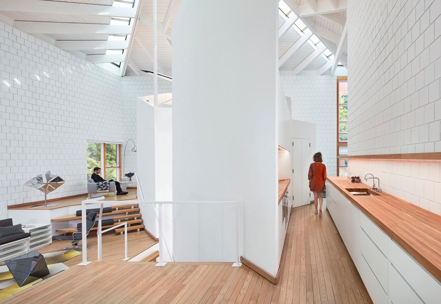 A long kitchen counter in Walter Netsch’s SOM-Renovated Chicago home runs parallel to an elevated office/living area level.