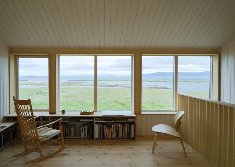 Mezzanine level in Studio Bua's renovated Icelandic barn overlooks the structure's gorgeous natural surroundings. 