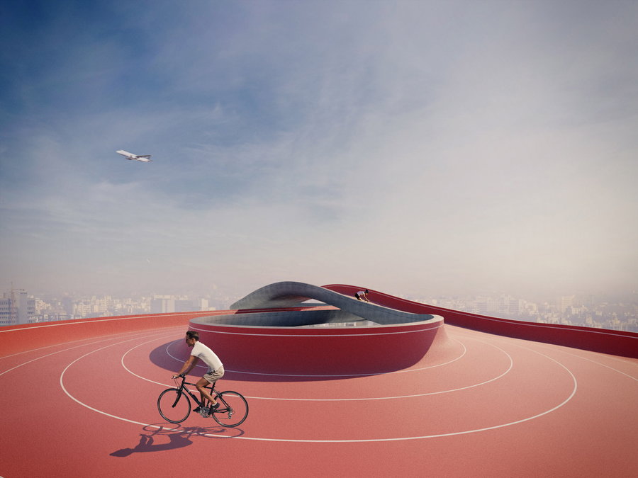 Cyclist makes their way along the infinity symbol-shaped rooftop track of the in-progress Forest School by NUDES.