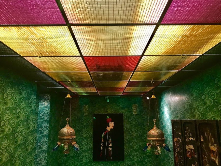 Lush green wallpaper patterns dominate this room inside NYC's re-created Turk's Inn supper club.