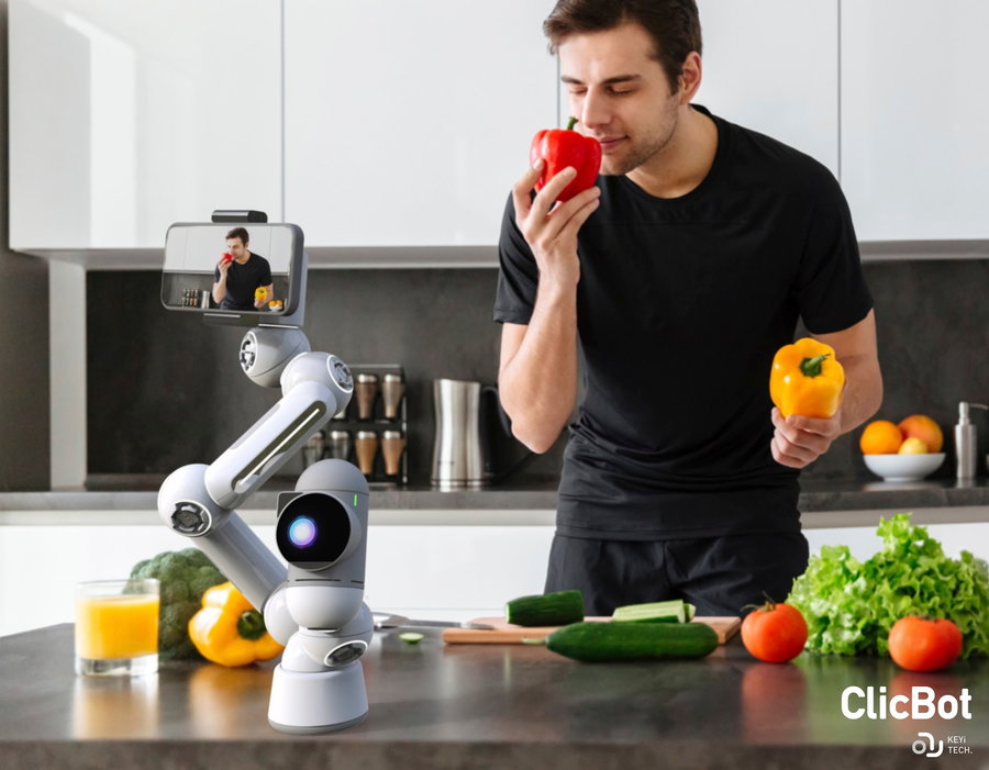 Young man uses his Clicbot in the kitchen to learn while he cooks.