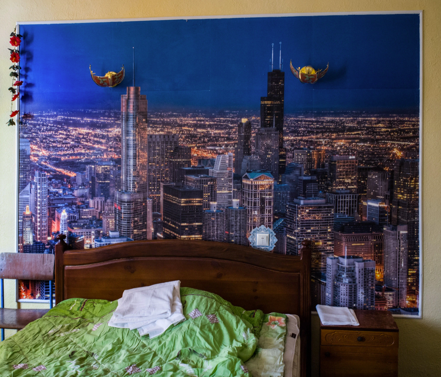 A light-feeling Ukrainian prion cell adorned with a large cityscape poster.