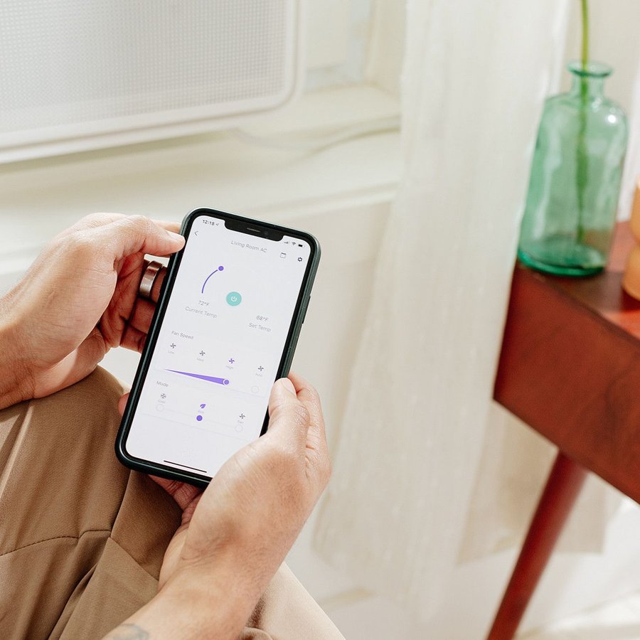 Person sets the preferred temperature for their Windmill AC unit using nothing but their smartphone.