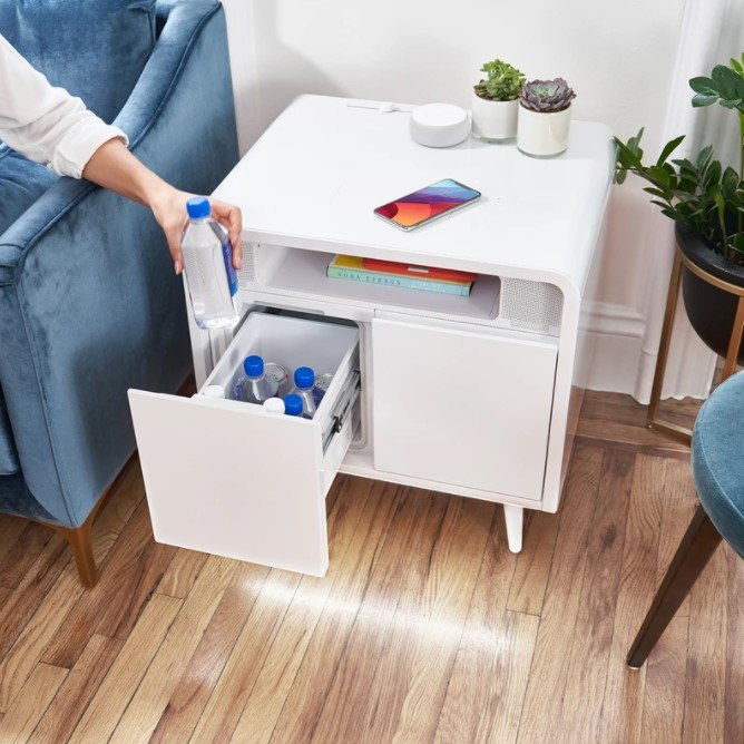 Person pulls an ice-cold drink from the Sobro Smart Side Table.