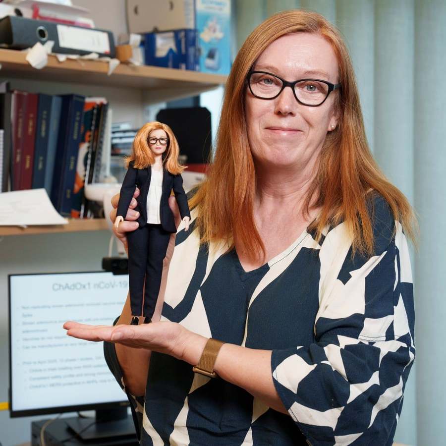 COVID-19 vaccine developer Sarah Gilbert holds up Mattel's newest Barbie doll, made in her likeness to honor her work during the pandemic. 