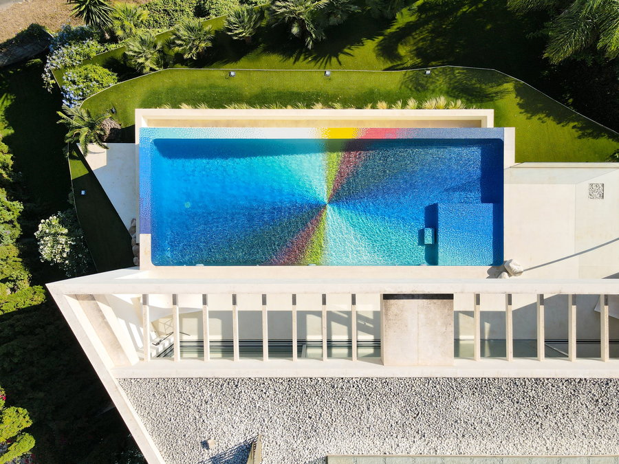 Colorful tiles create a pinwheel design by Felipe Pantone on the bottom of a swimming pool in Javea, Spain. 