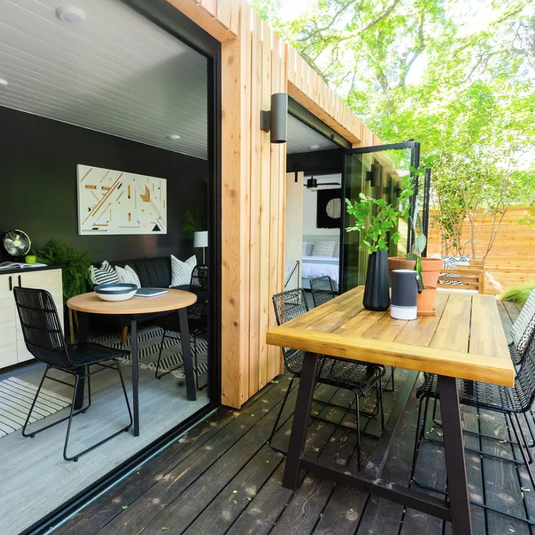 Large operable windows and a rustic outdoor deck make this Airbnb feel incredibly connected to nature.