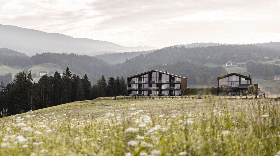Exterior view of the two barn-like buildings that make up noa's new AEON Hotel in northern Italy.