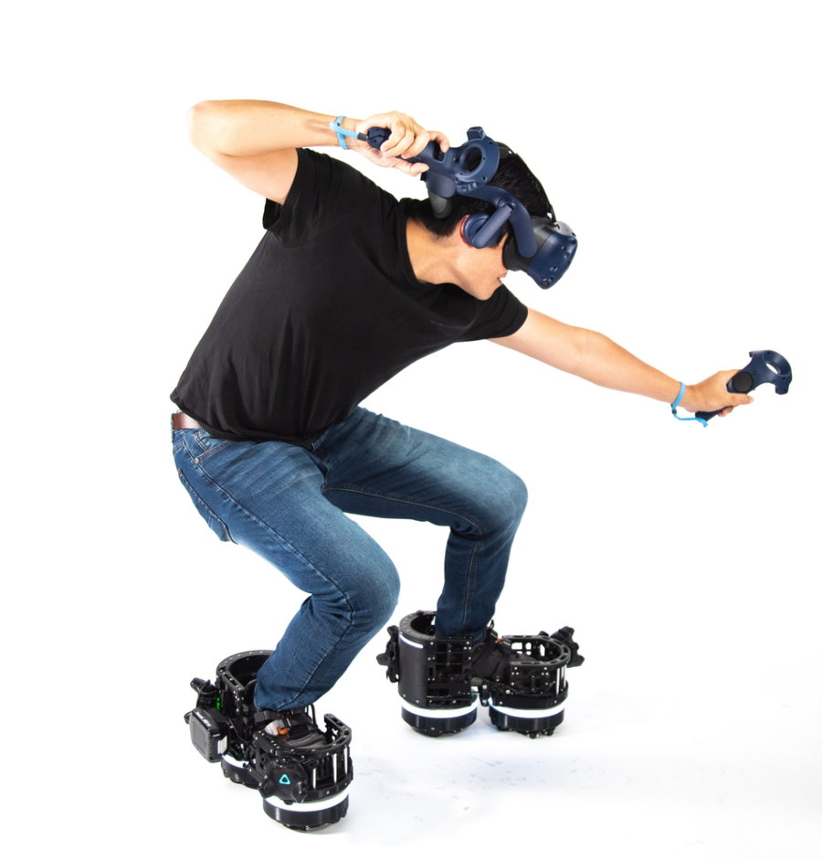 Gamer strikes a defensive pose while donning a VR headset and the new Ekto One VR boots.