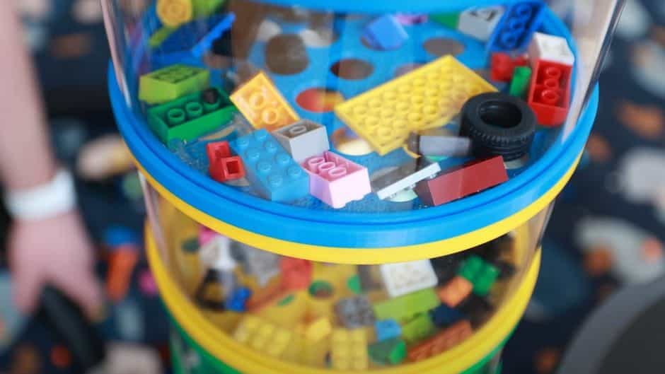 Close-up view of the different shape compartments inside Matty Bendetto's LEGO vacuum. 