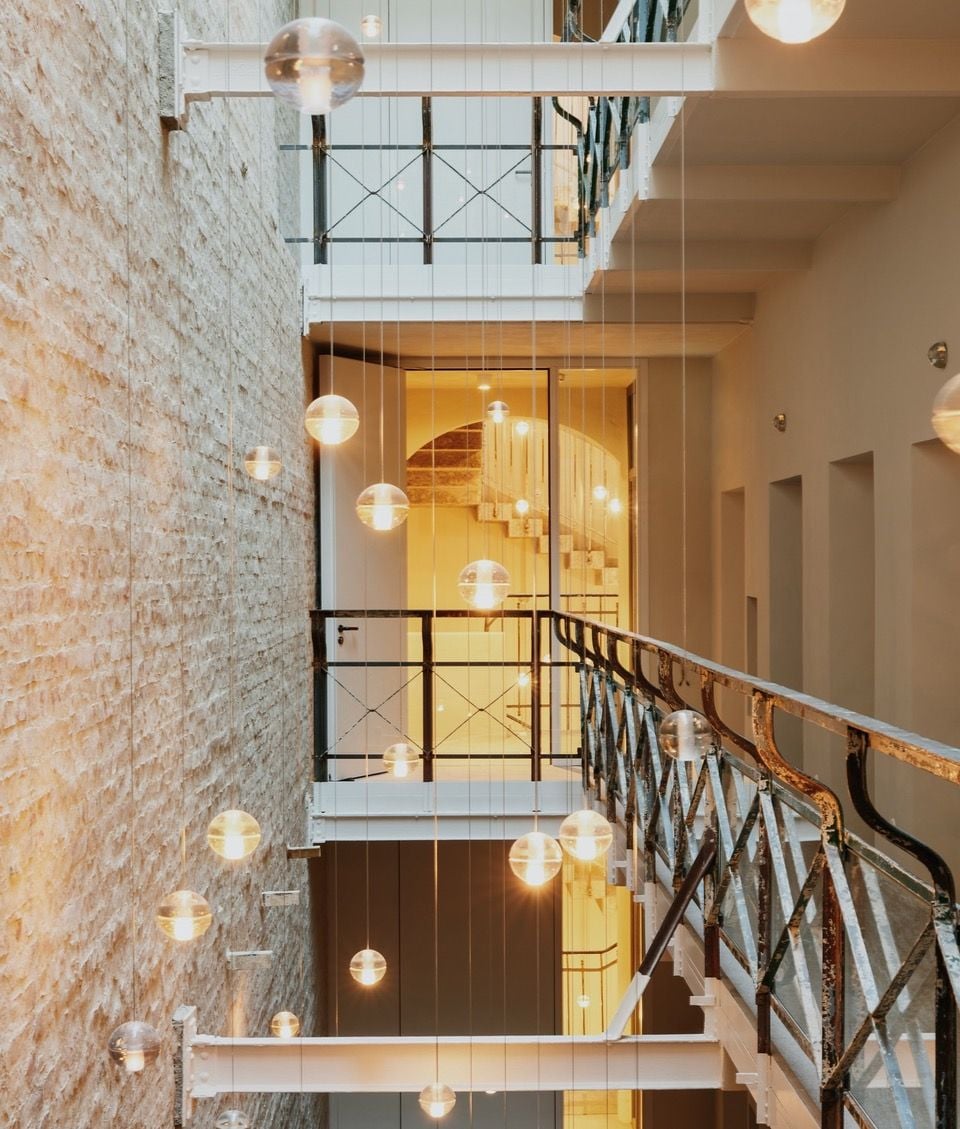 Globe lights hang over the Wilmina Hotel's central atrium for a light, modern look. 