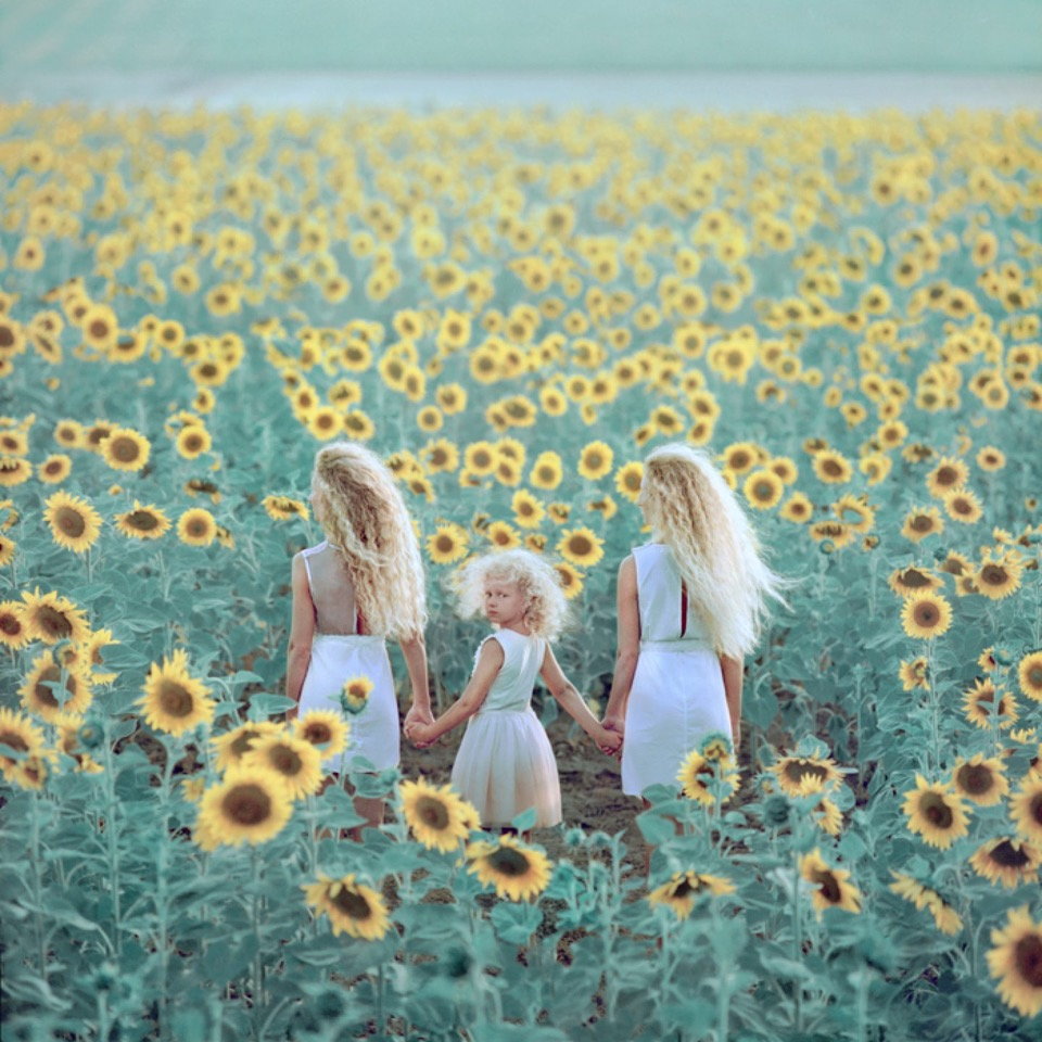 Surreal photograph by Ukrainian artist Oleg Oprisco shows Ukrainian children standing in a sunflower field.