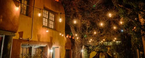 Night time enchantment only on the grounds of Pueblo Bonito b&b! A one of a kind massive adobe pueblo compound steeped in historical archetictural elements, Truly a traditional Old Santa Fe experience..