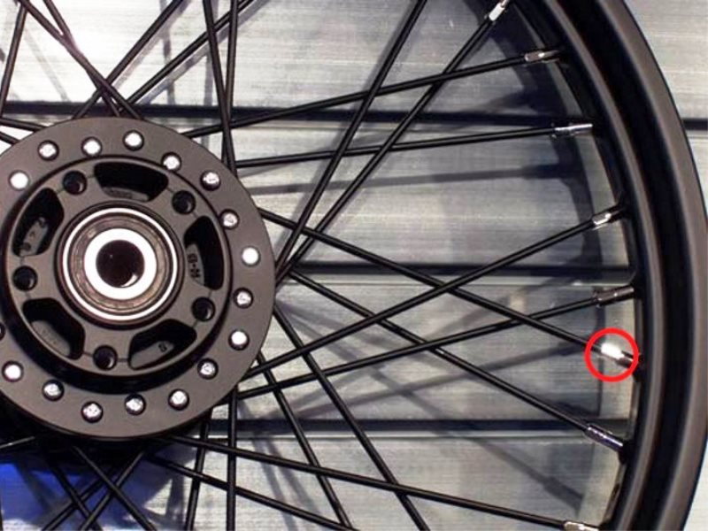 Turn the nut near the rim for spoke adjustment