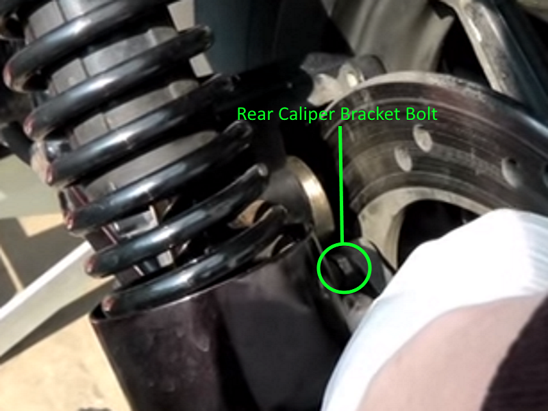 Location of the rear caliper bracket bolt