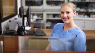 Young woman at work as receptionist in a doctor's office.