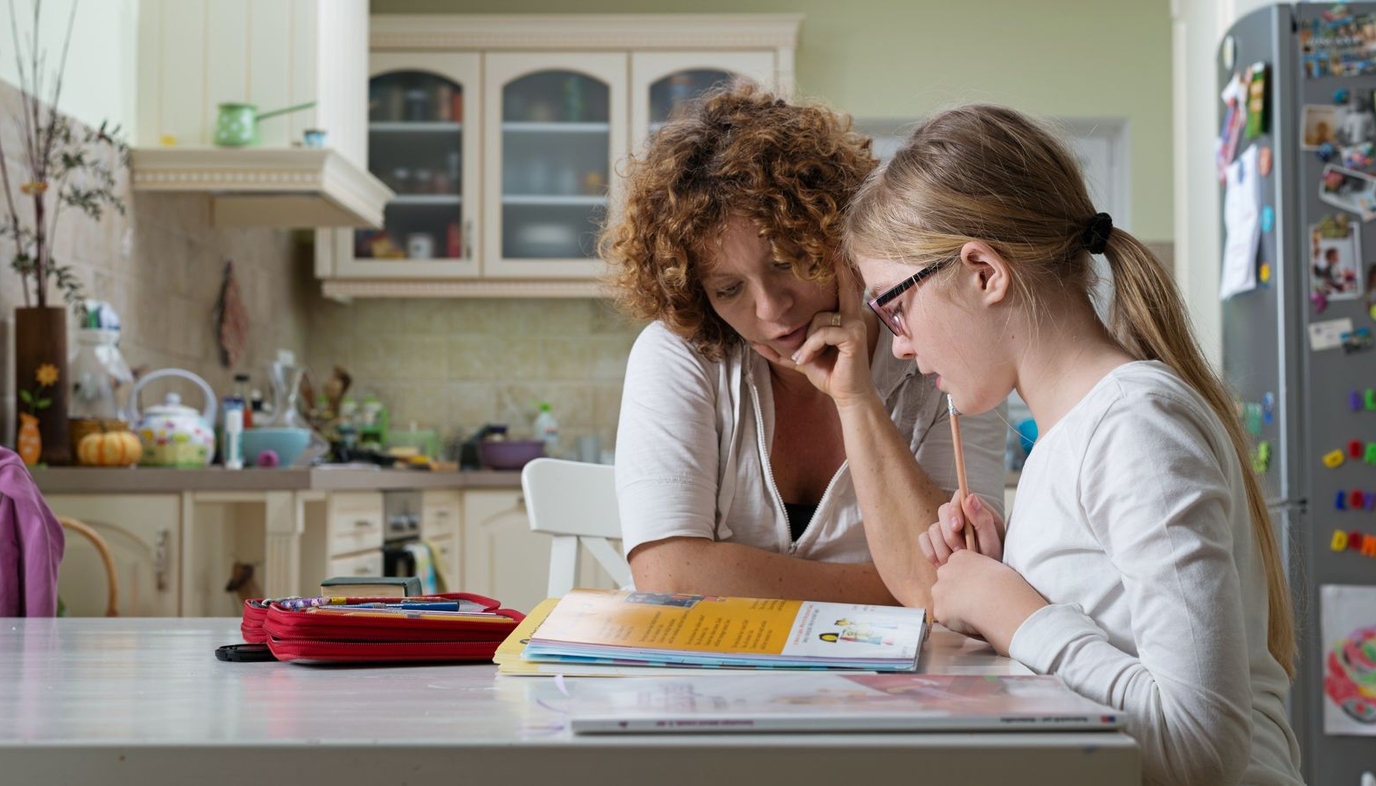 mom helping daughter with homework