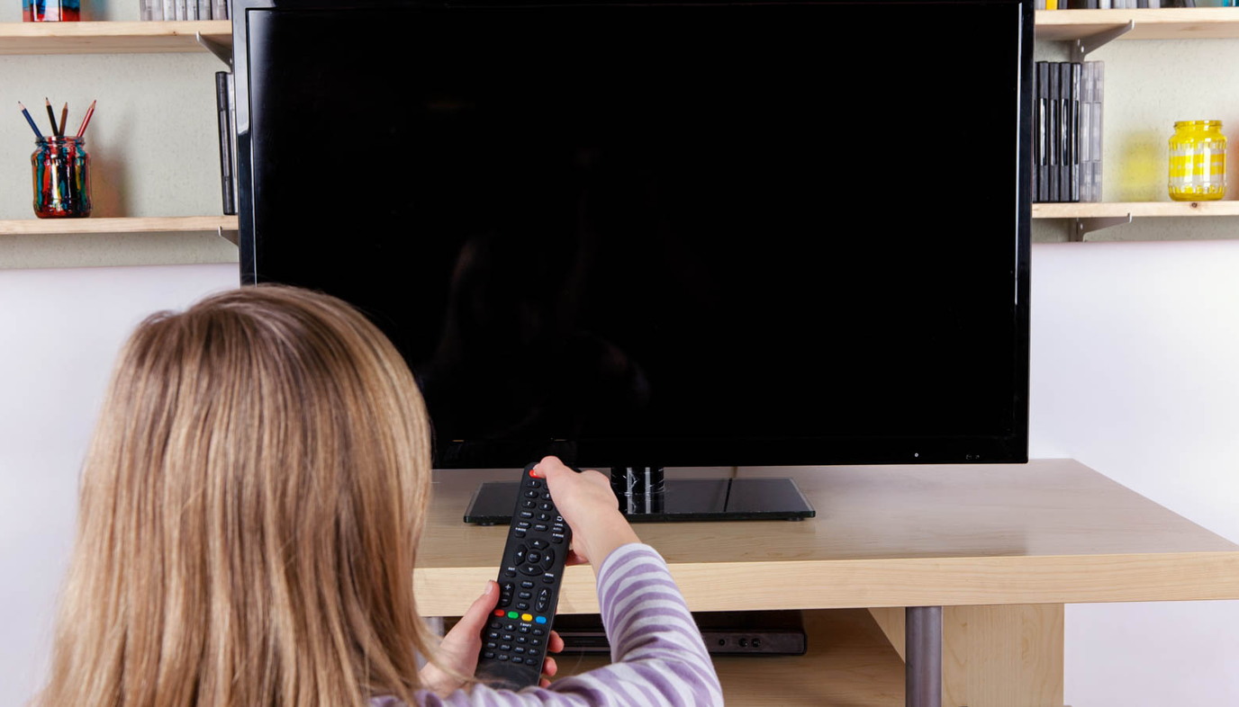 little girl turning off the television