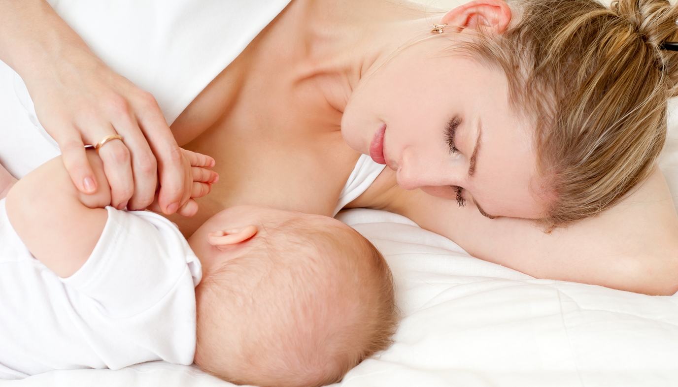mother lying down breastfeeding