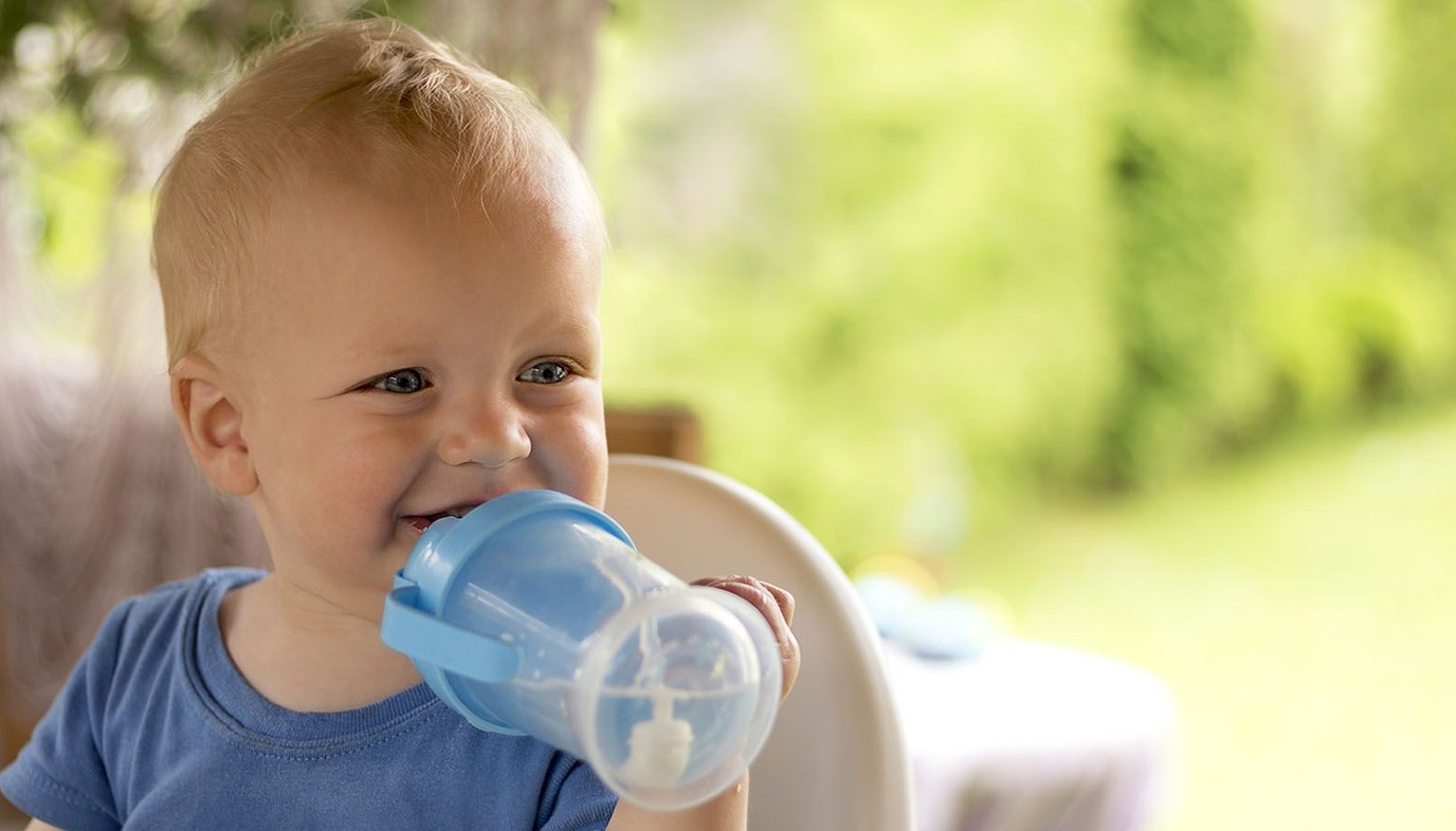 baby drinking out of a sippy cup