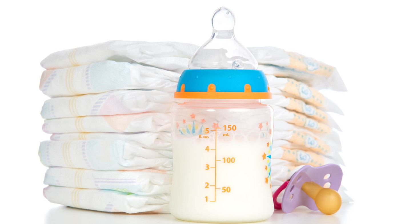 baby diapers next to baby bottle