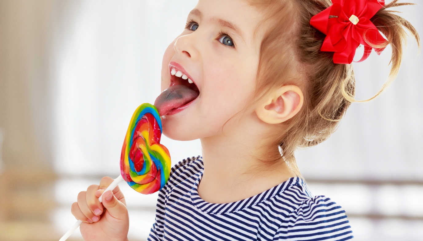 girl licking lollipop