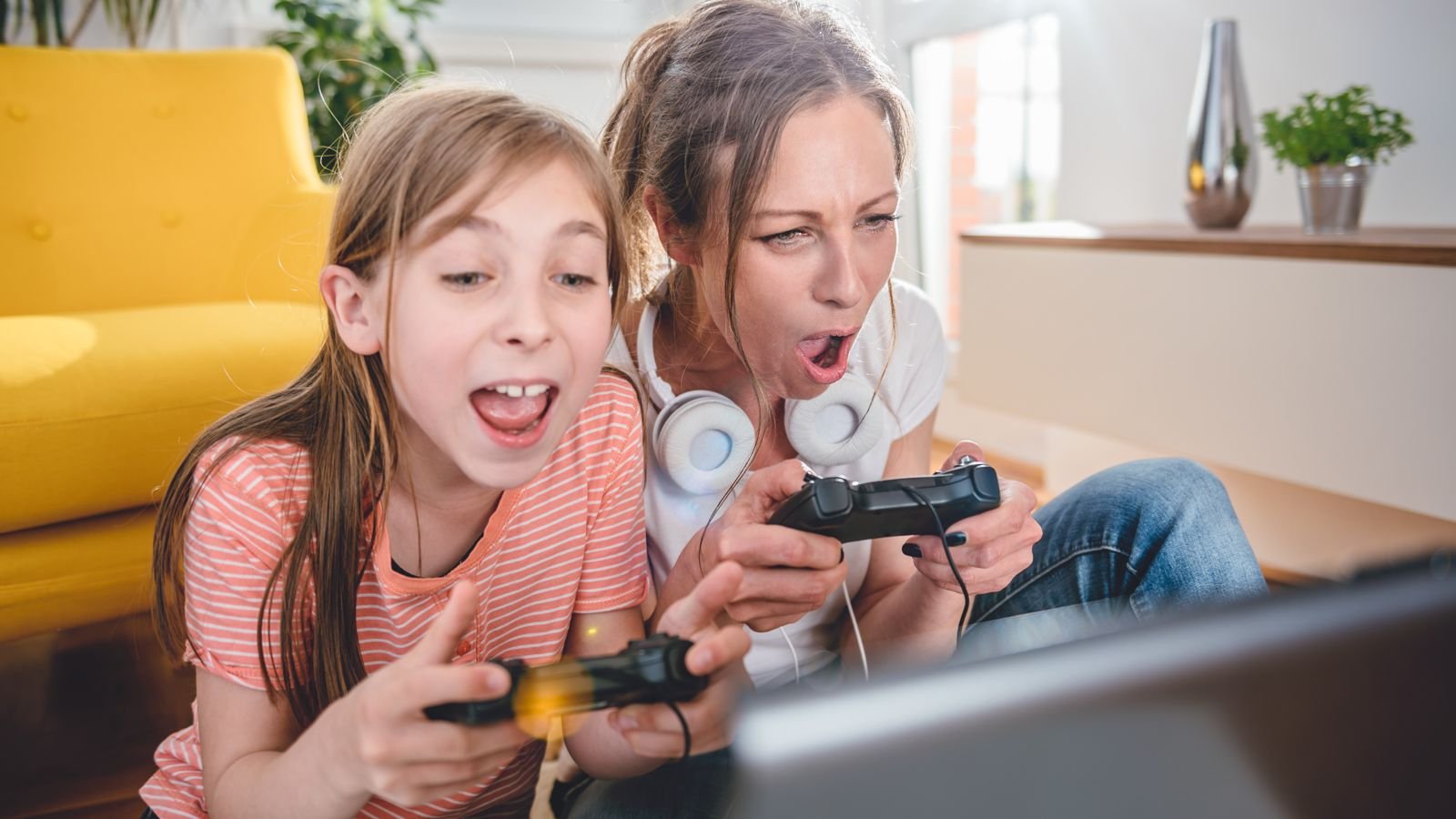 mom playing video game with daughter