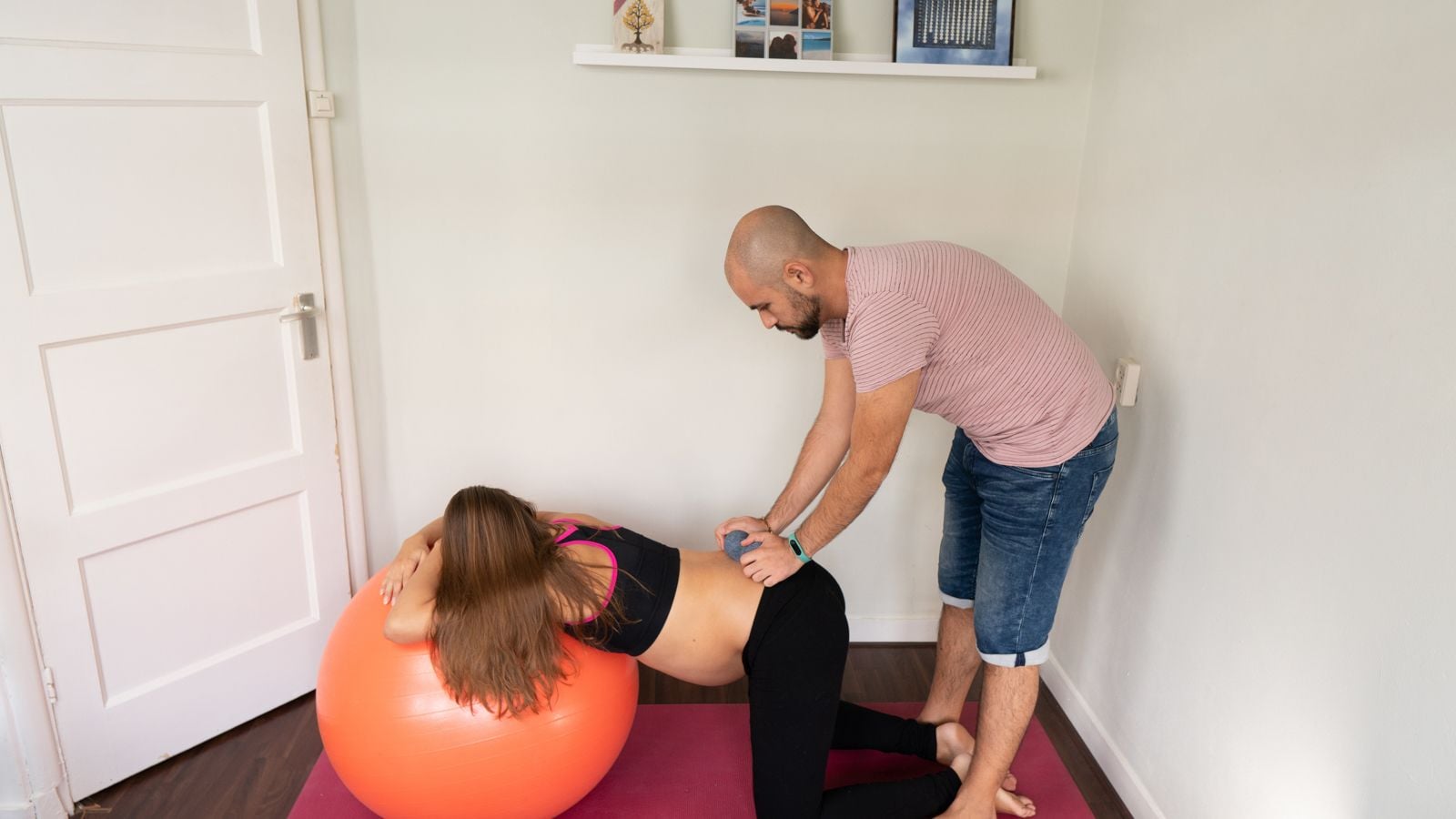 pregnant mom leaning over exercise ball