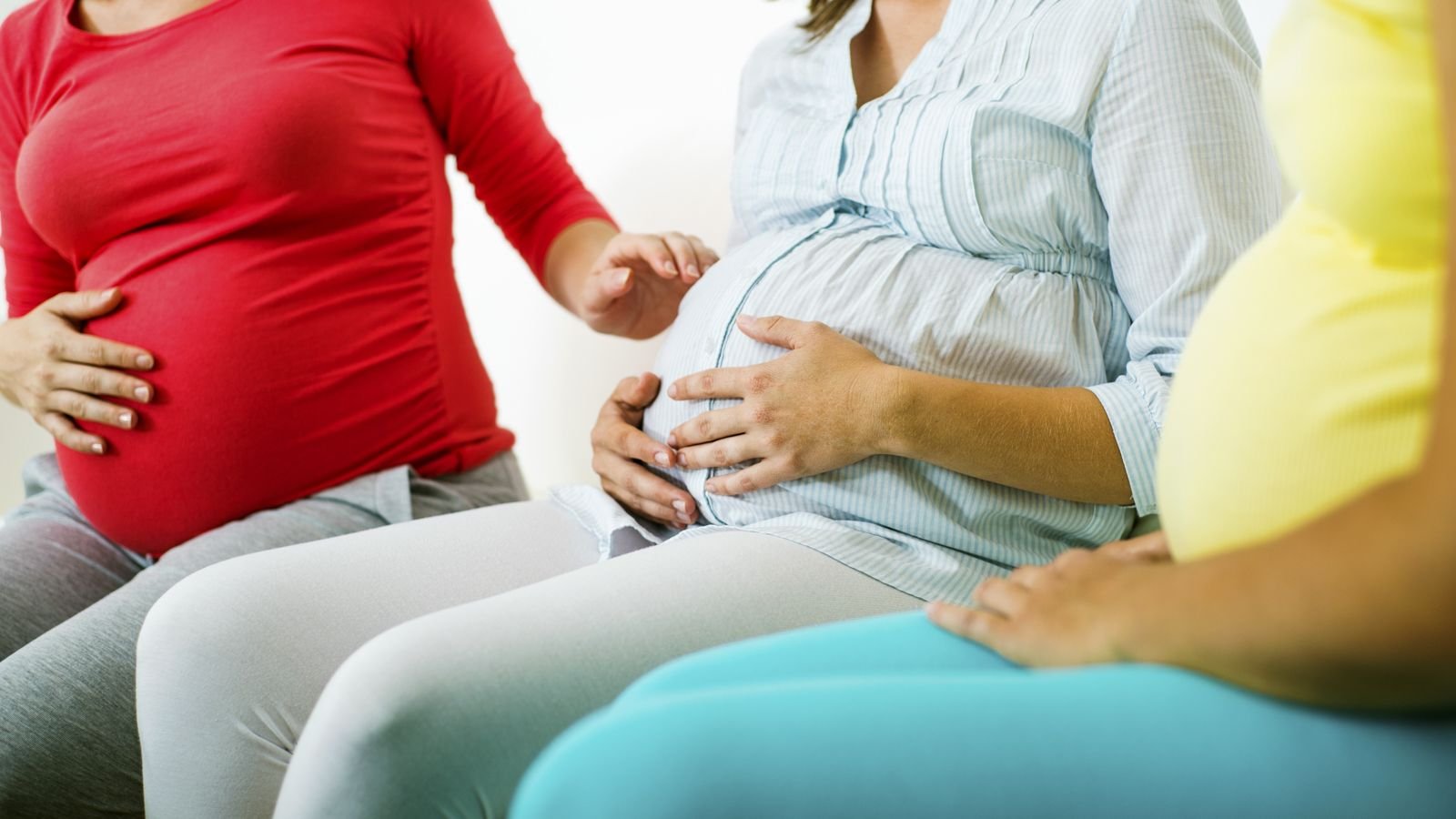 pregnant friends sitting on a sofa