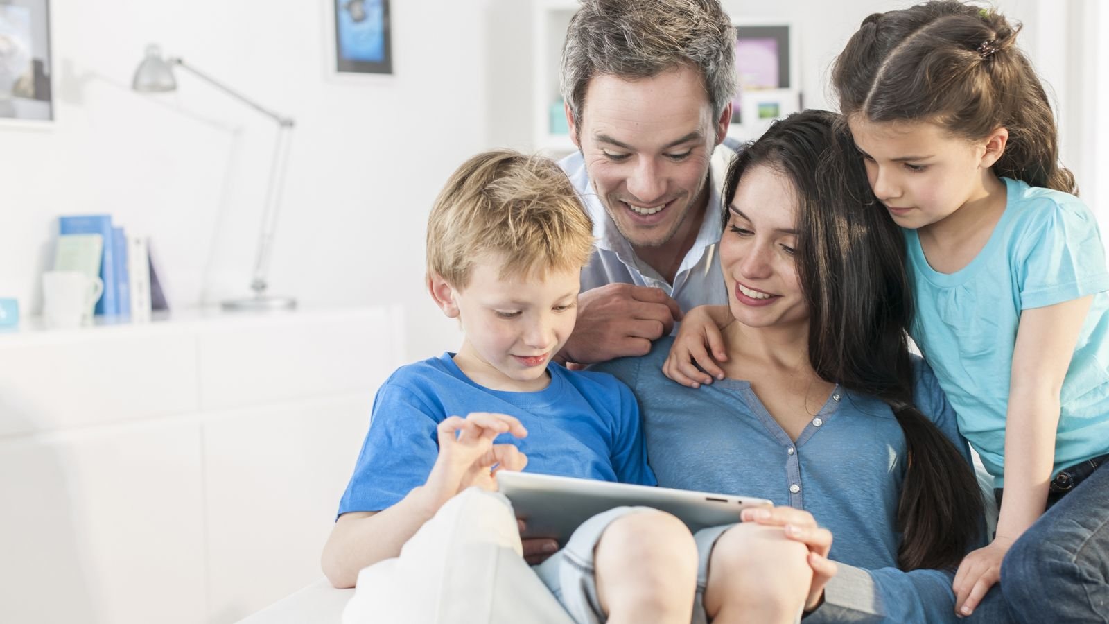 family playing on tablet together