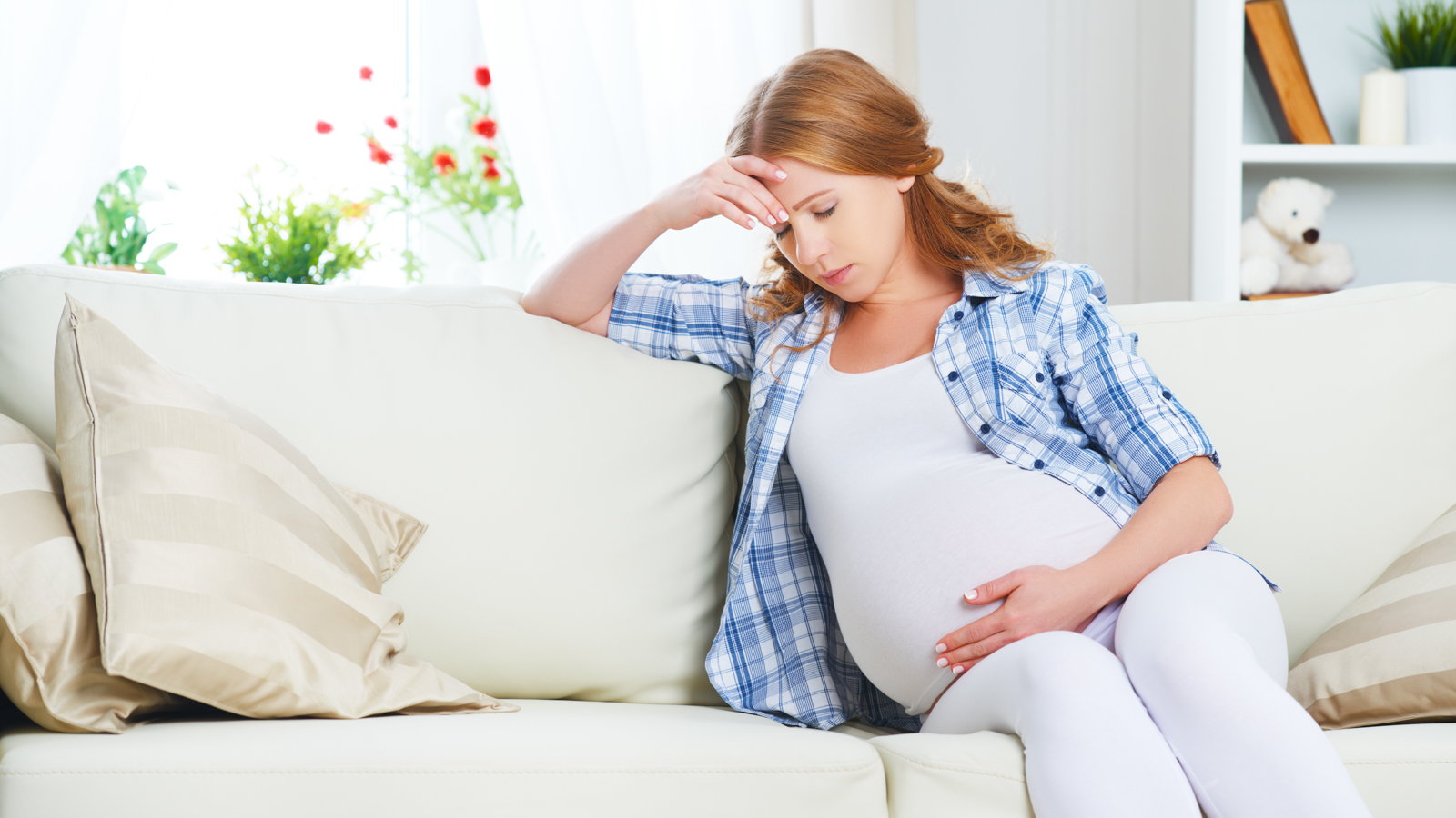 pregnant woman on couch having pain
