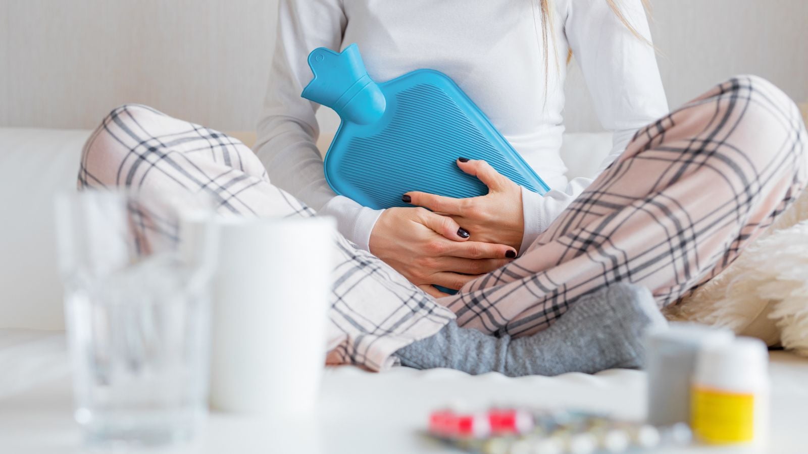 woman holding ice pack on belly