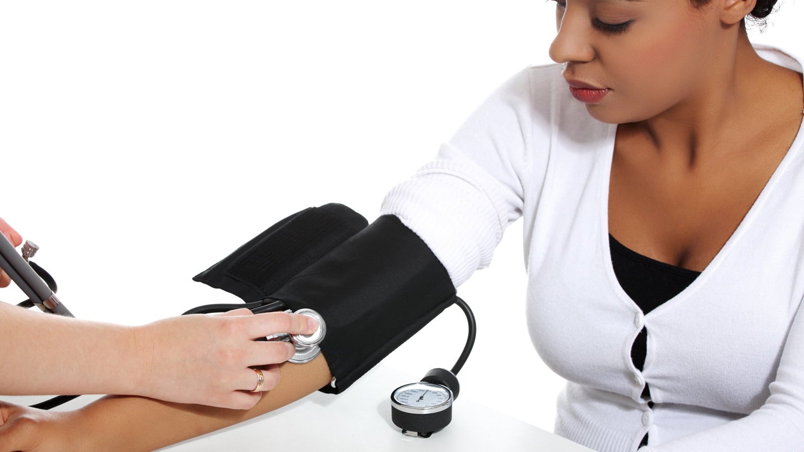doctor checking woman's blood pressure
