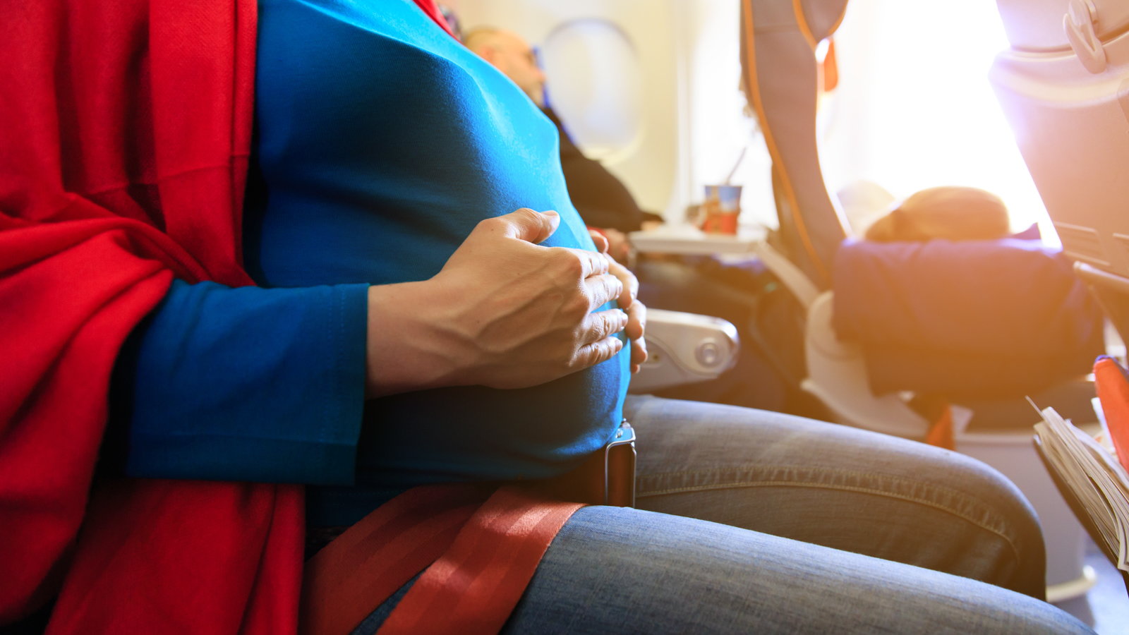 pregnant woman sitting on plane