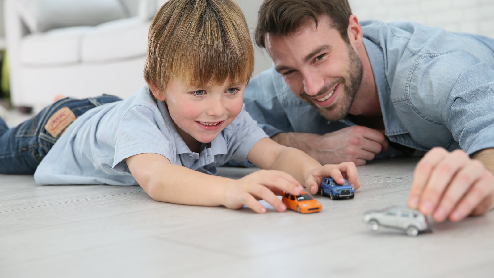 dad and son playing with cars