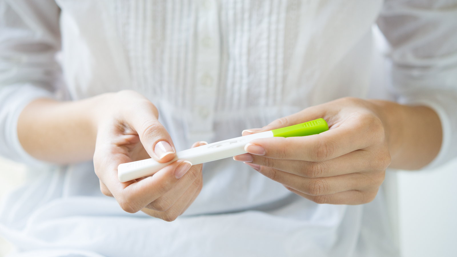 woman looking at ovulation test