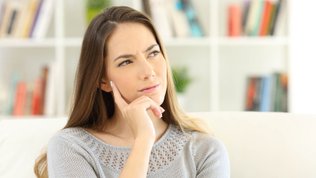 thoughtful woman when do pregnancy symptoms start