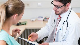 Woman reviewing medical information with a doctor pregnancy don'ts