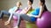 pregnant women stretching on exercise ball