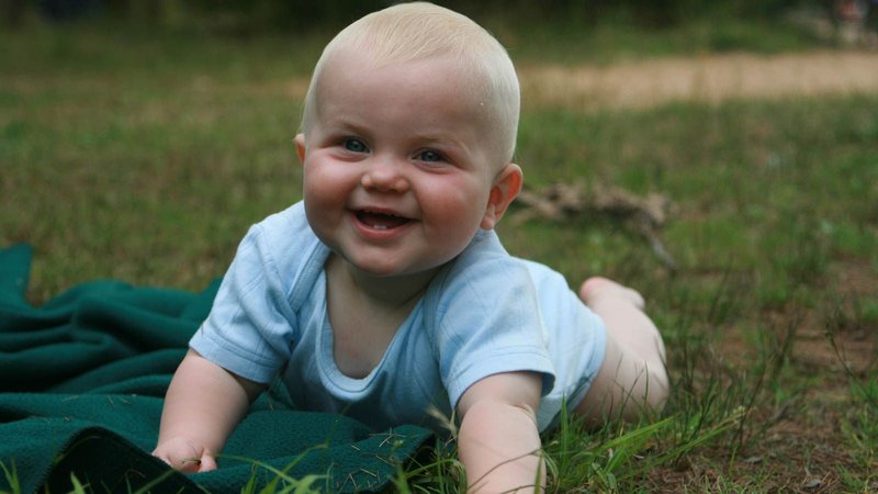 baby crawling in the grass