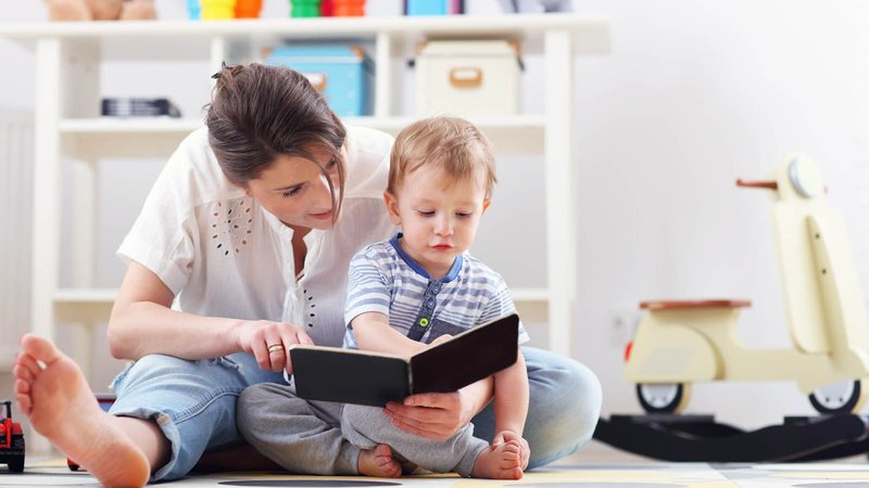 mom reading book to baby