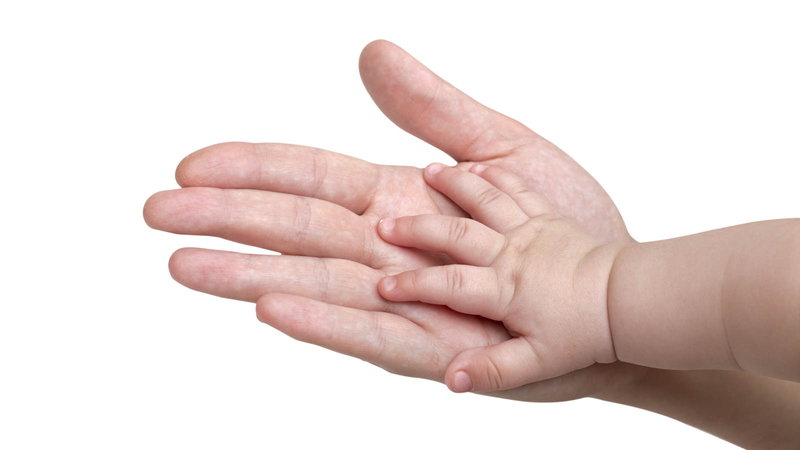 baby hand on parent's hand