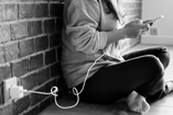 person charging a smartphone while using social media