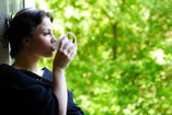 woman sitting in veranda drinking tea