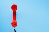 A red support and referral addiction recovery hotline phone.