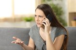 angry woman trying to keep calm during a phone call