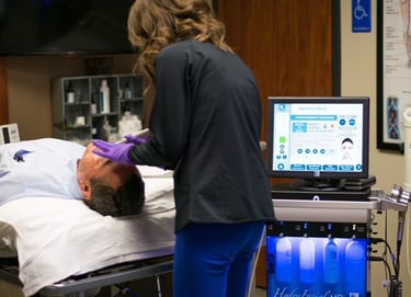 Kendra Maag performing procedure on a patient.