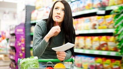 A mother looking over her grocery list.