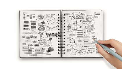 A notebook with scribbles and graphs. 