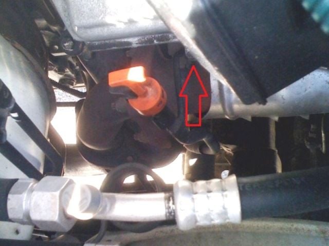Remove the 12 mm bolt holding the transmission dip stick in place